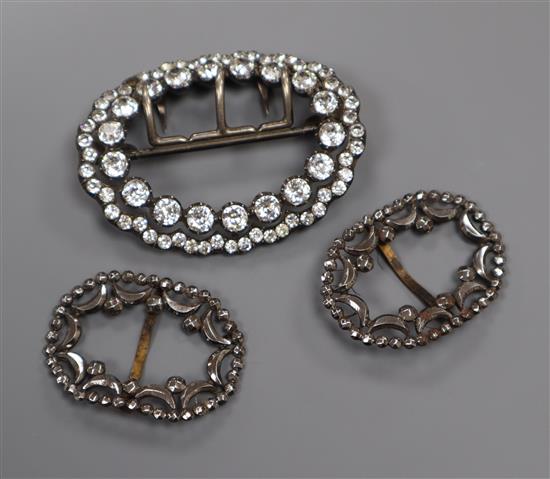 A pair of Georgian cut steel shoe buckles and a white metal and paste set buckle,